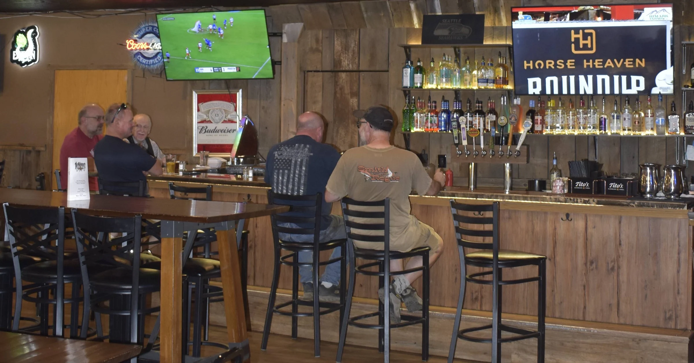 Guests sitting along the bar during service