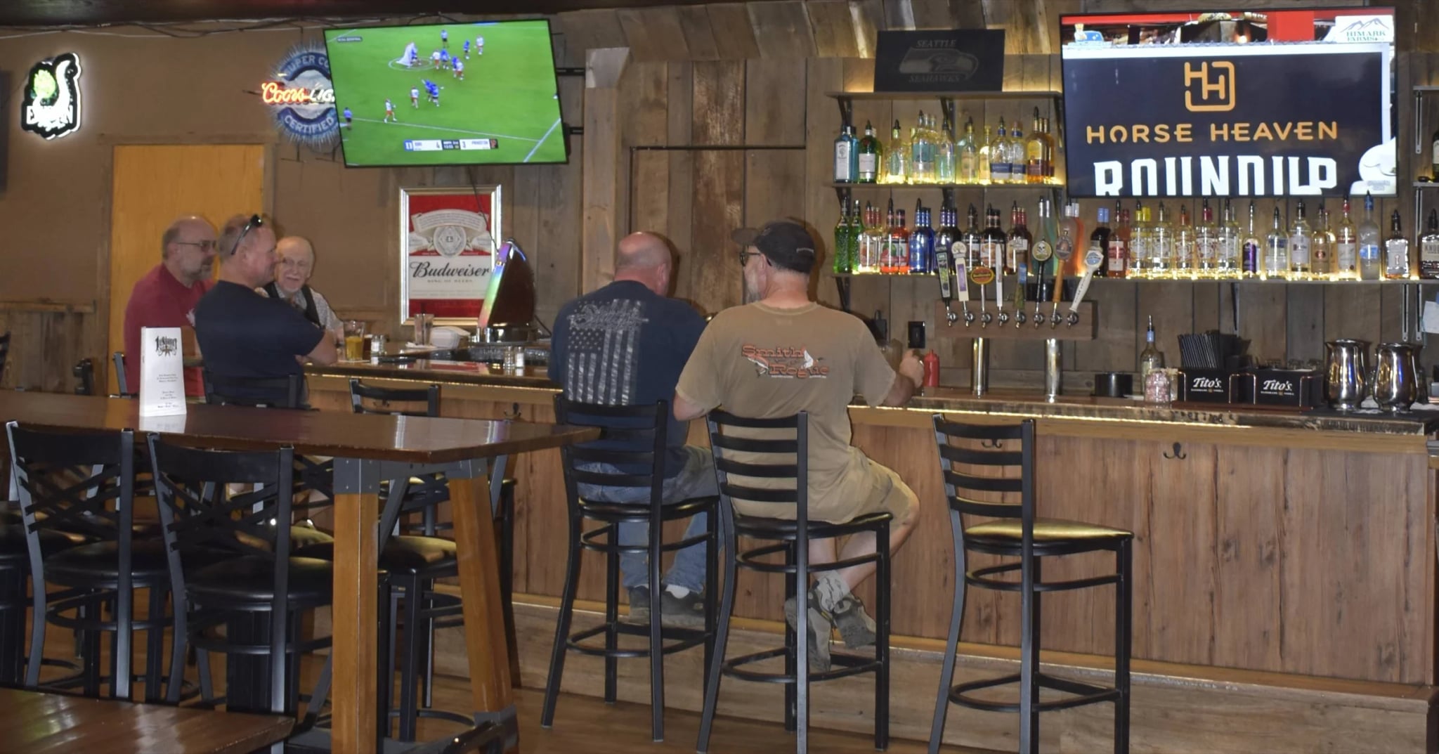 Guests sitting along the bar during service
